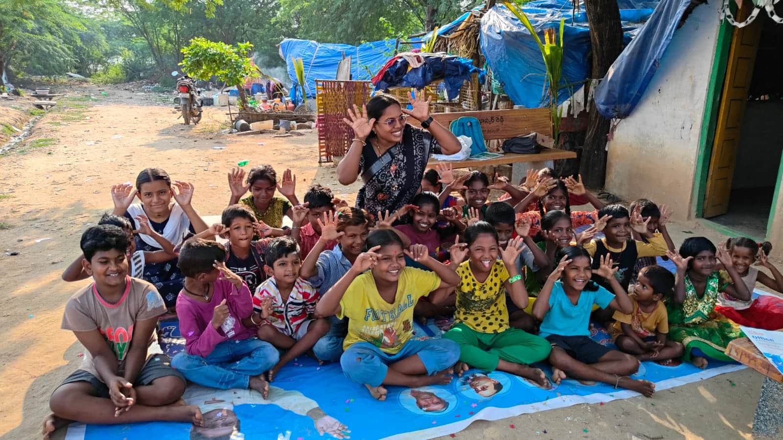 Children cheering at an Akshara Dhaathree study centre