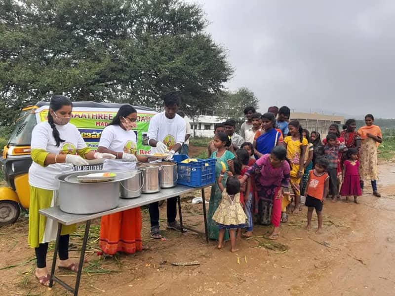 Volunteers serving food to families