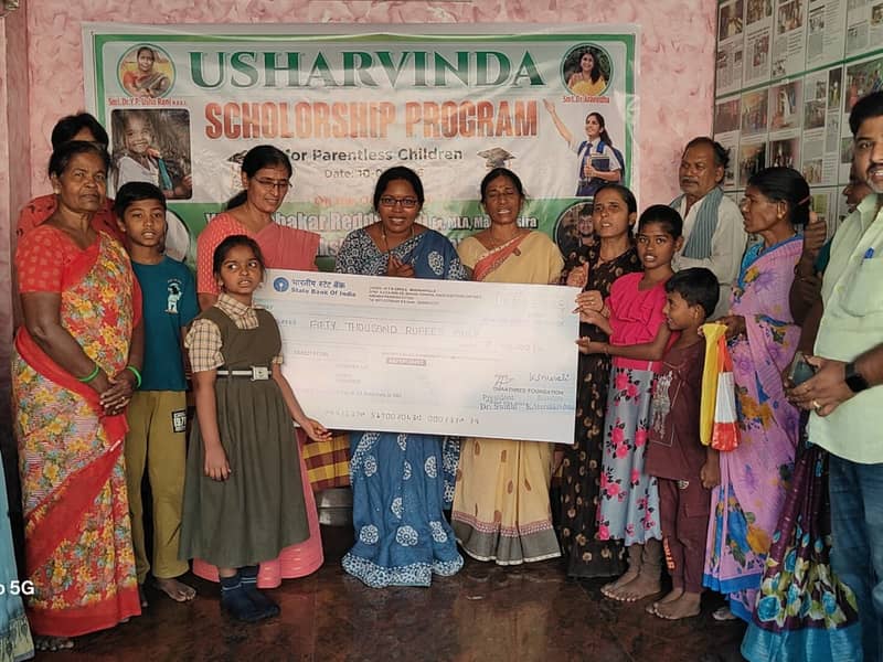 Handing over a scholarship cheque with a sponsor